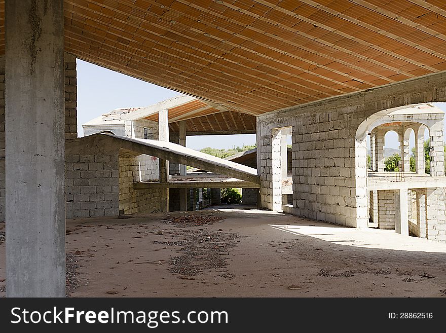 House under construction with reinforced concrete columns and concrete blocks.
Inside the building, you see bricks, pillars and concrete blocks. House under construction with reinforced concrete columns and concrete blocks.
Inside the building, you see bricks, pillars and concrete blocks.