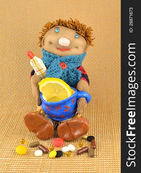 Handmade toy with pills, cup of tea and slice of lemon. Handmade toy with pills, cup of tea and slice of lemon