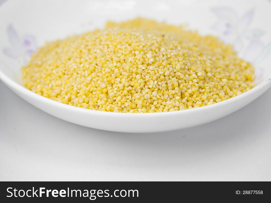 An image of yellow millets in a bowl