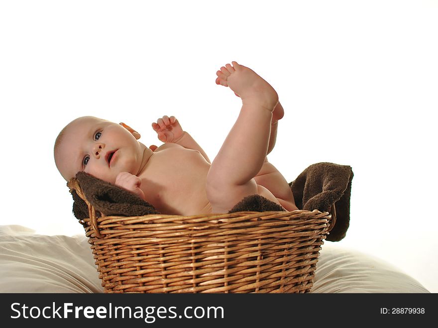 Newborn baby in the basket on white background. Newborn baby in the basket on white background