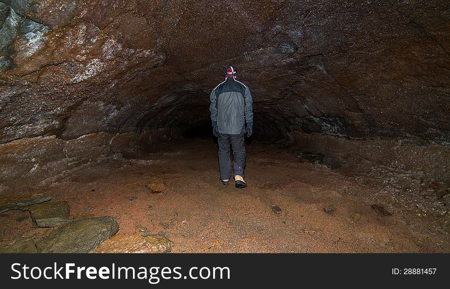 A man walking in a cave.