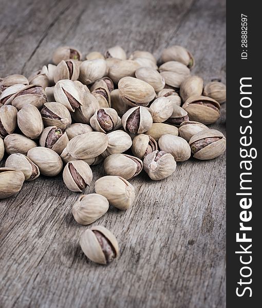Roasted pistachios on natural wooden table