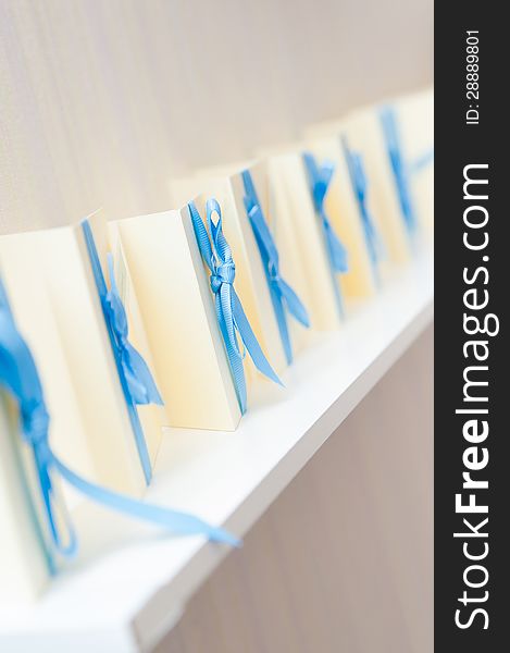 Many blank invitation cards standing in a row