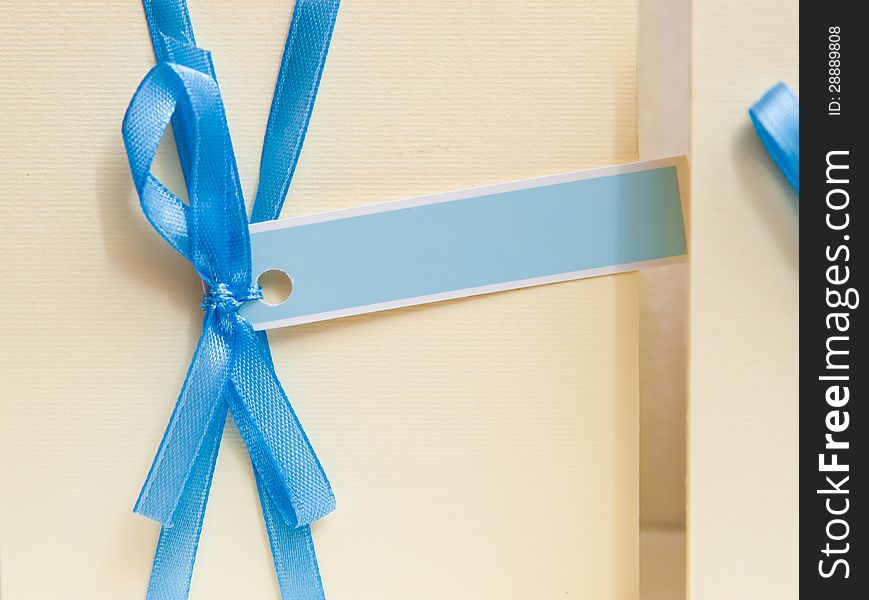 Blank invitation card with an inscription place. decorate blue ribbon bow
