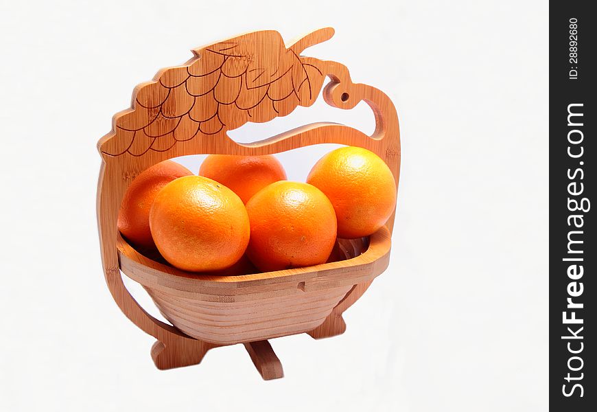 Desertnyi set of ripe oranges in a wooden shopping cart. Desertnyi set of ripe oranges in a wooden shopping cart