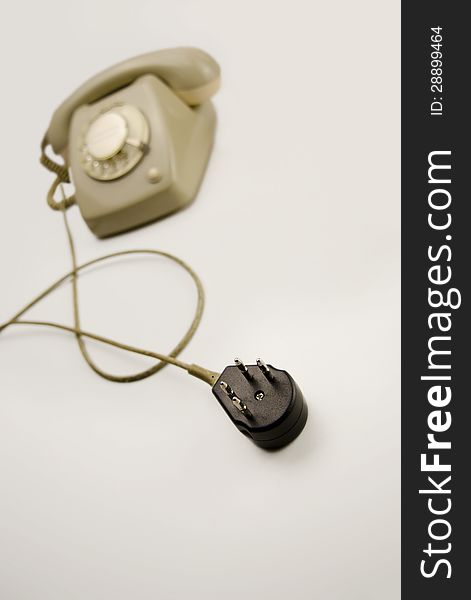 Unplugged analog gray telephone black connecting plug