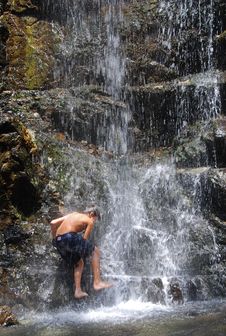 Boy Climbing The Waterfall Stock Image