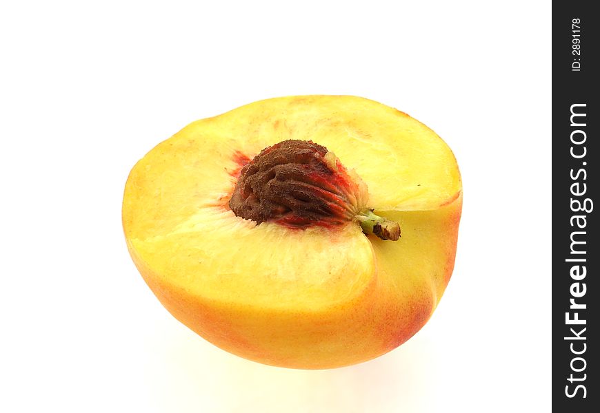 Half of peach with stone on white background