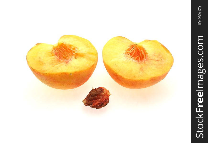 Two halfs of peach and stone on white background