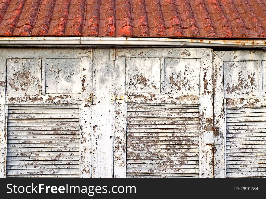 Old garage doors with red roof. Old garage doors with red roof