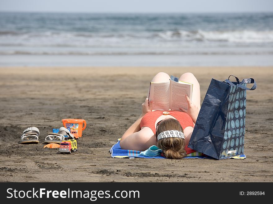 Woman reading on the beach. Woman reading on the beach