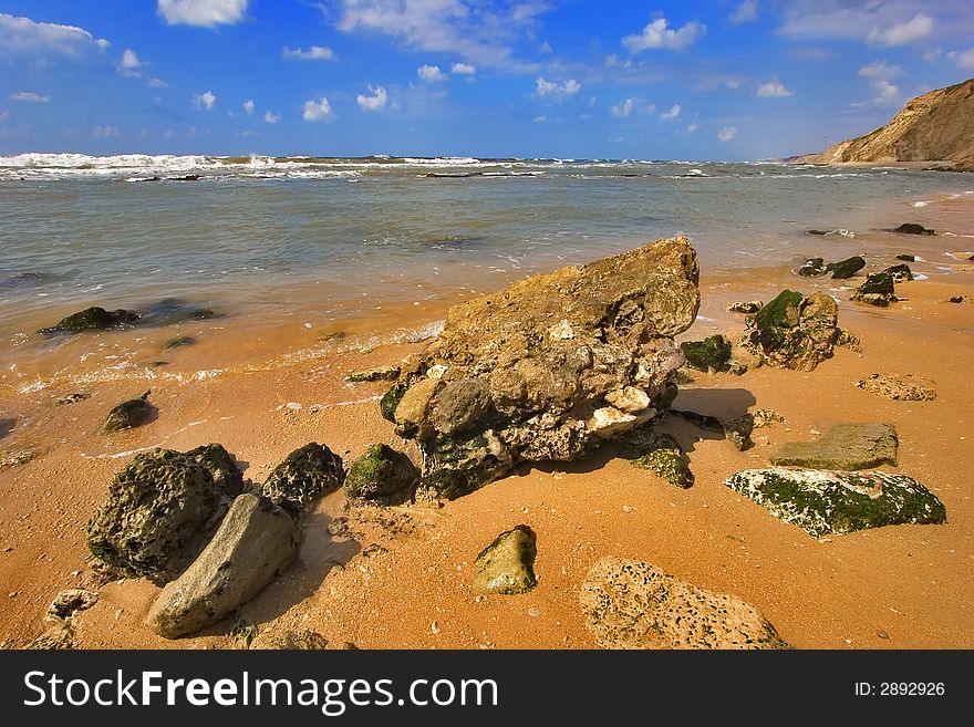 Coast of Mediterranean sea with big stones in water. Coast of Mediterranean sea with big stones in water