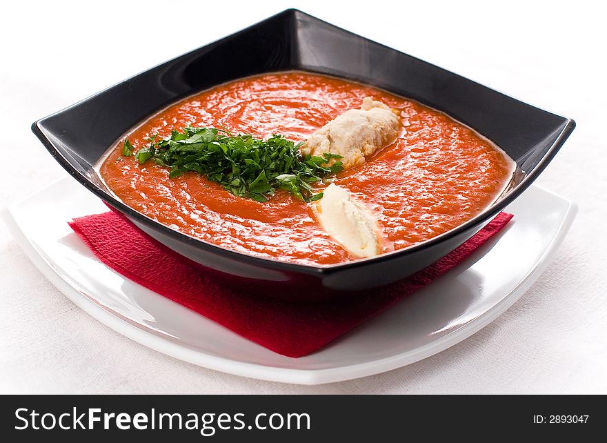 Tomato soup with chicken musse and green