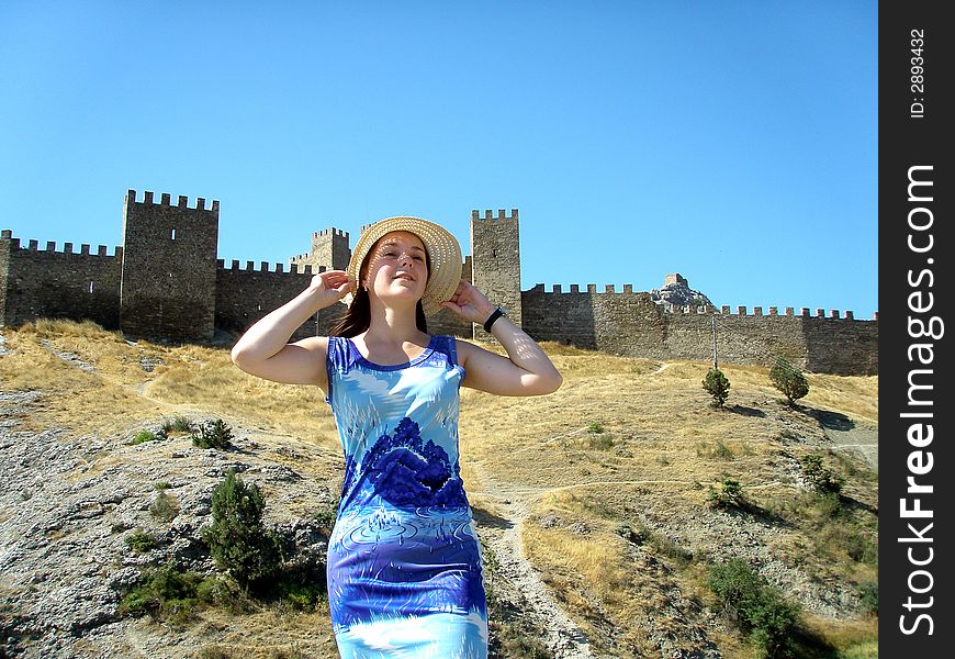 Laughing girl near ancient fort