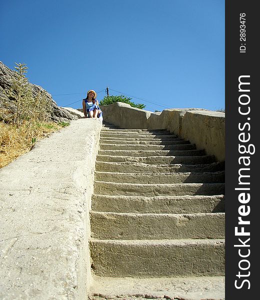 Girl is sitting on ancient staircase. Girl is sitting on ancient staircase