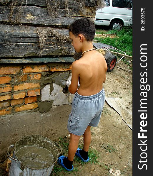 Boy with trowel and cement