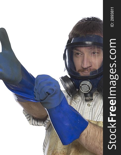 Man with hazardous waste mask puts on blue chemical gloves with a mock serious expression. Man with hazardous waste mask puts on blue chemical gloves with a mock serious expression.