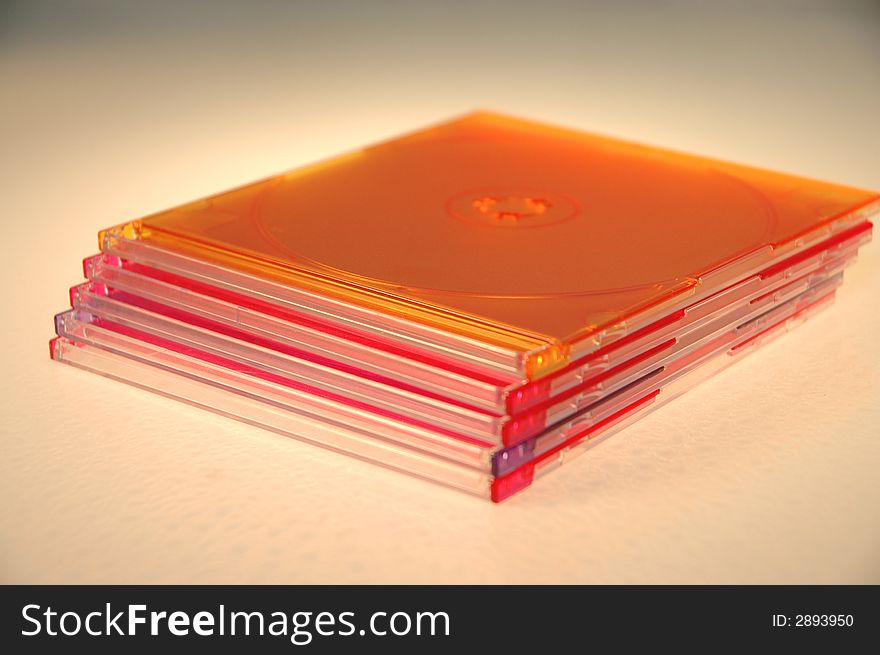 A stack of colored  CD-ROM cases against a white background. A stack of colored  CD-ROM cases against a white background.