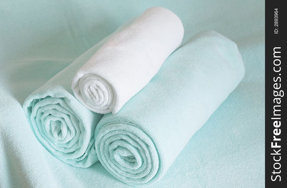 Light green towels rolled and ready to be used