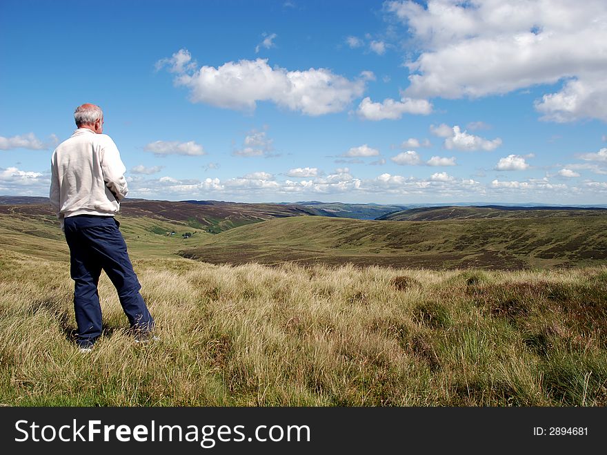 A man enjoying the view in Snowdonia, North Wales. A man enjoying the view in Snowdonia, North Wales.