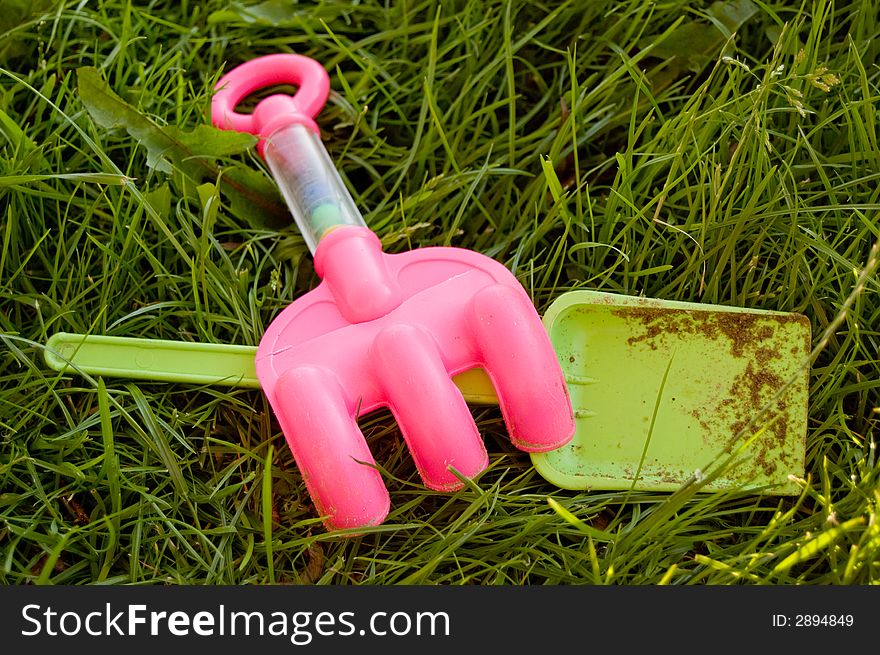 Rake and shovel in the grass