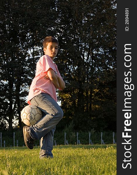 Boy holding soccerball with leg. Boy holding soccerball with leg