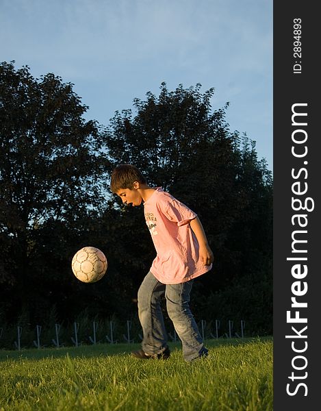 Boy is keeping a soccerball high. Boy is keeping a soccerball high