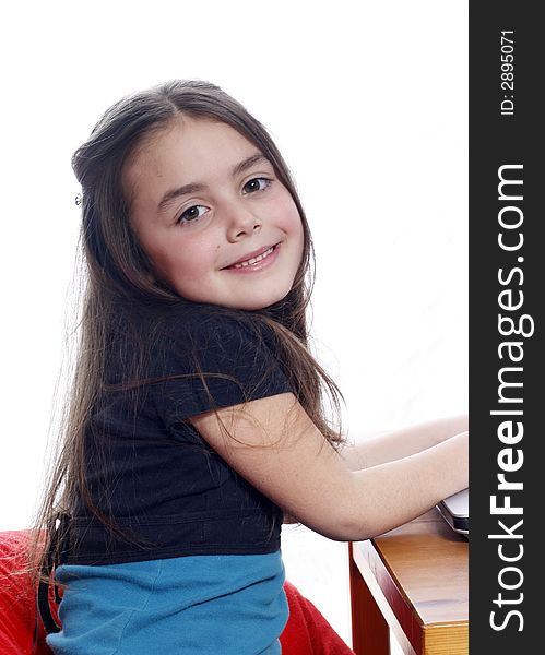 Young girl sitting down and smiling. Young girl sitting down and smiling