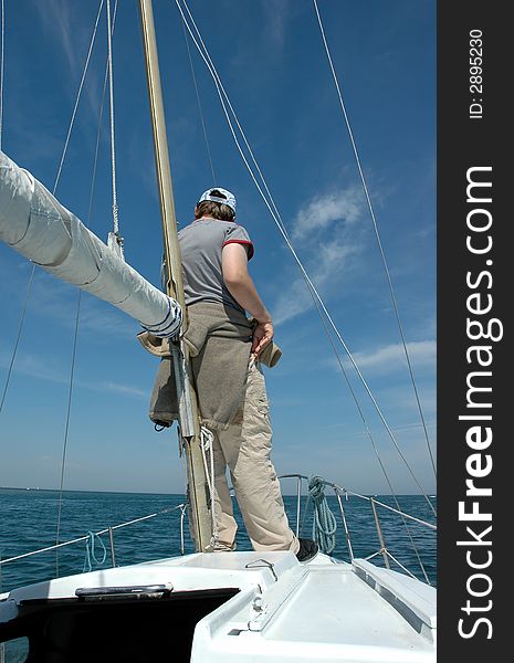 A young boy at the bow of a sailing boat. A young boy at the bow of a sailing boat.