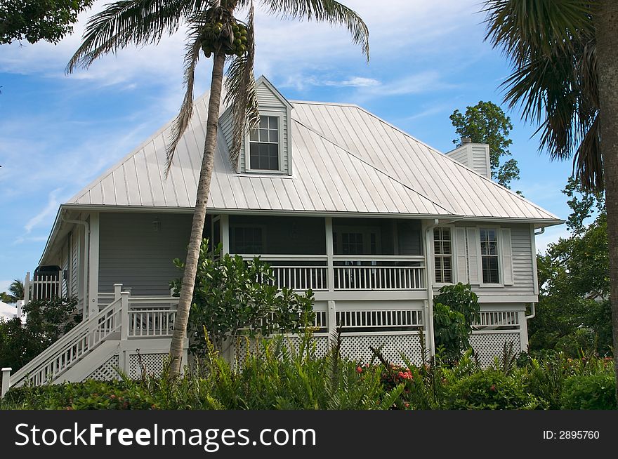 Tropical beach setting with a beautiful Florida style home. Tropical beach setting with a beautiful Florida style home