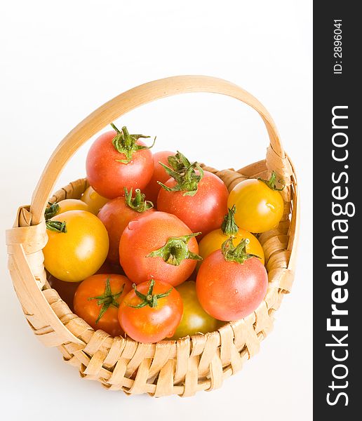 Basket with red and yellow cherry tomatos. Basket with red and yellow cherry tomatos