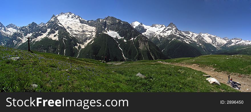 Bicycle on a background of snow mountains and meadow. Bicycle on a background of snow mountains and meadow