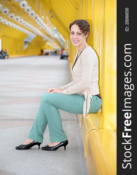 Young woman sitting on pedestrain bridge