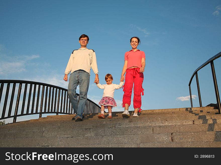 Parents with daughter on stone ladder. Parents with daughter on stone ladder