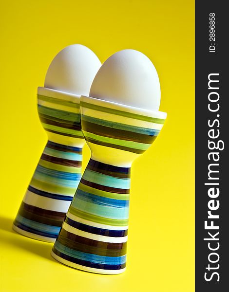 Boiled eggs in tall striped egg-cup