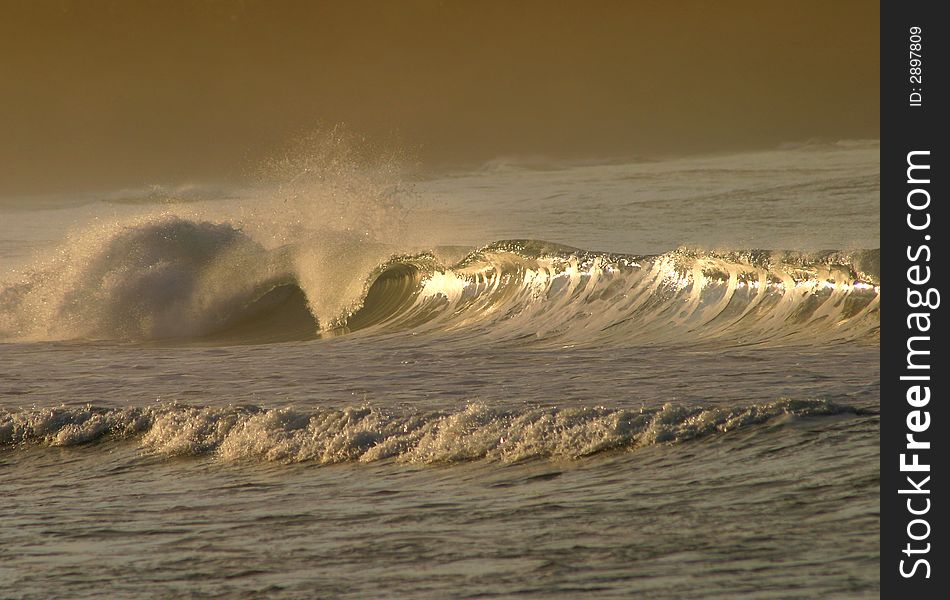 Photo of a breaking wave near the shore during the dusk in Puerto Viejo, Costa Rica. Photo of a breaking wave near the shore during the dusk in Puerto Viejo, Costa Rica
