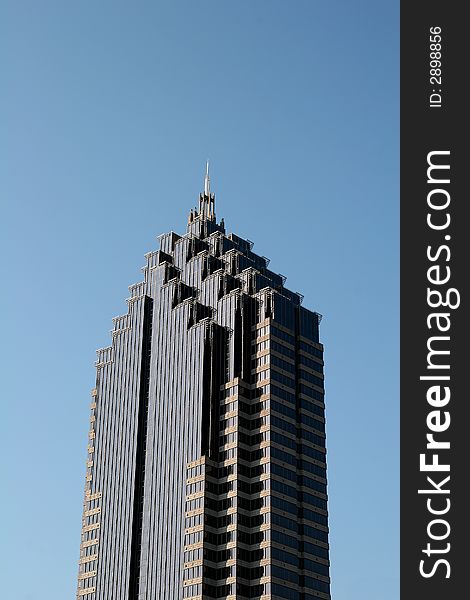 A modern glass office tower with terraced top. A modern glass office tower with terraced top