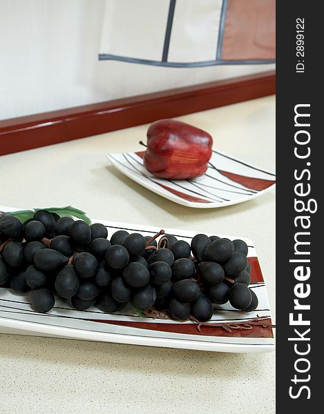 Grapes and apple on modern and beautiful kitchen