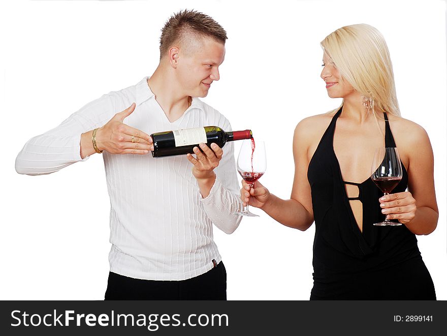 Happy young couple celebrating - pouring the wine