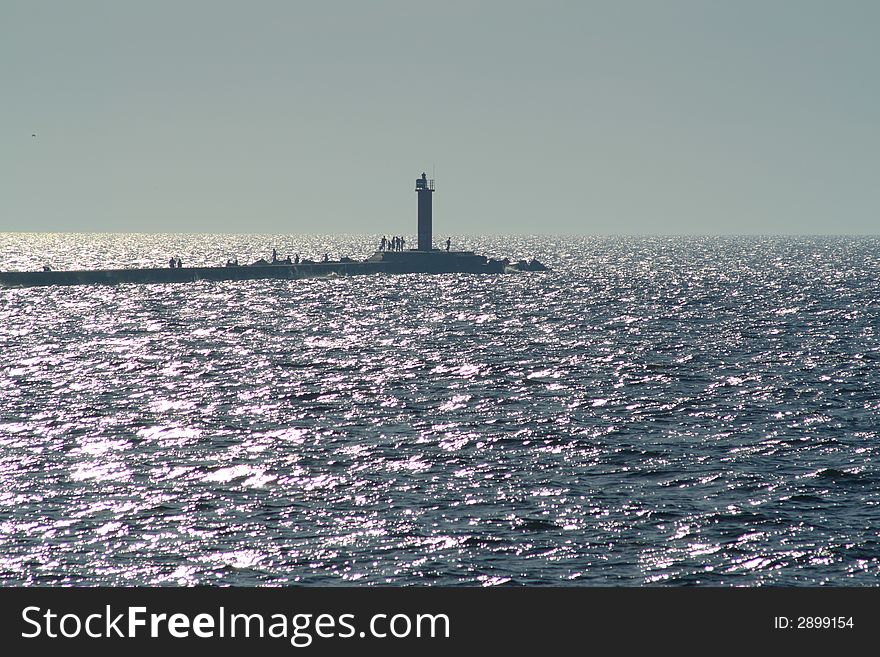 Lighthouse on pier in the sea