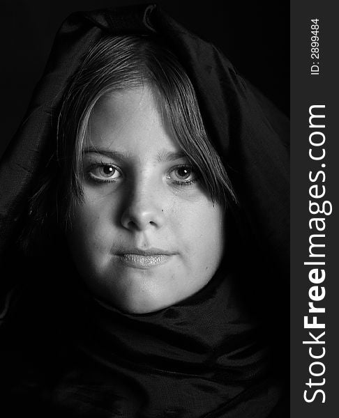 Dramatic portrait of a teen girl with her head wrapped.