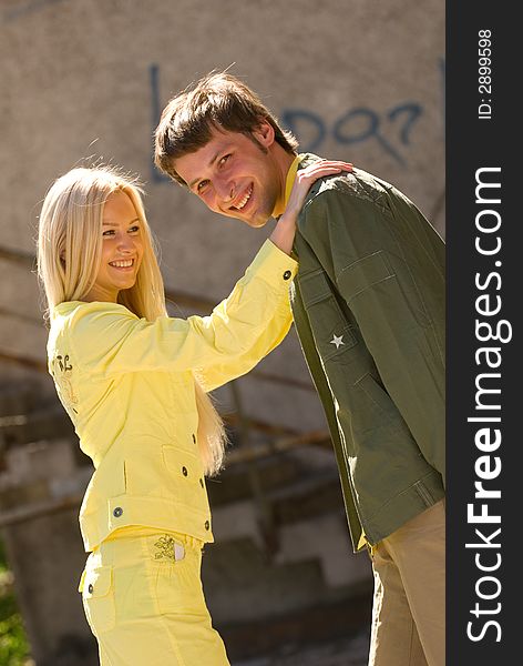Cheerful young couple on the grunge background. Cheerful young couple on the grunge background
