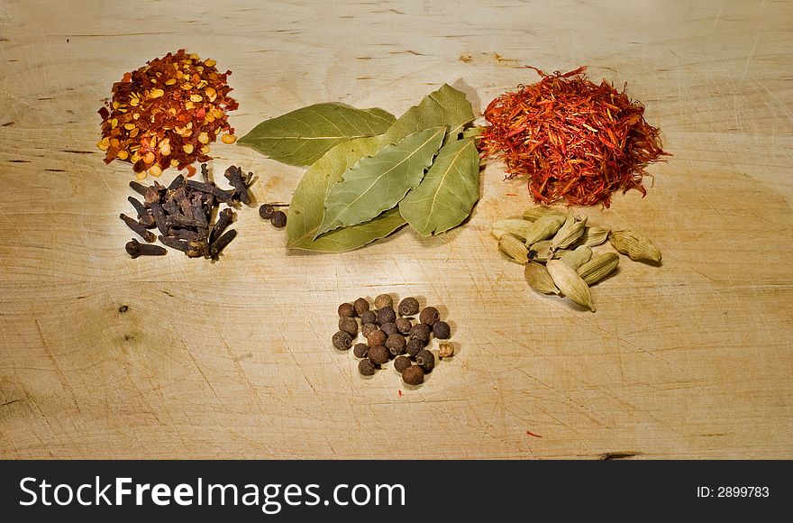 Iscellaneous spices on wooden board