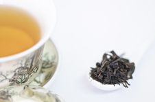 Cup Of Chinese Tea With Dry Tea Leaves  On White Background Stock Photos