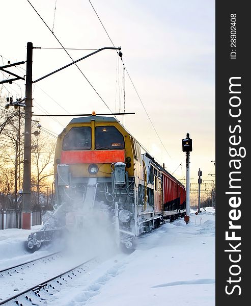 Locomotive with wagons on a railway line in a winter morning