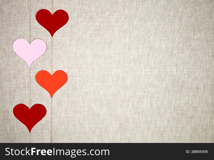 Hearts garlands on linen background