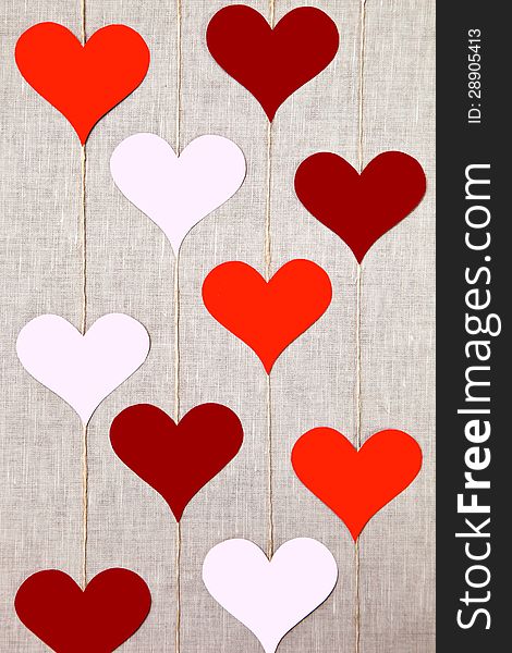 Hearts garlands on linen background