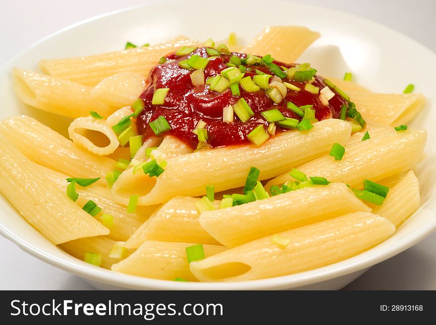 Pasta with tomato sauce and green onions