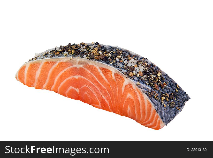 Fresh salmon steak with spices on a white background.