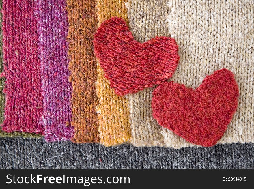 Two red hearts on colorful fabric. Two red hearts on colorful fabric